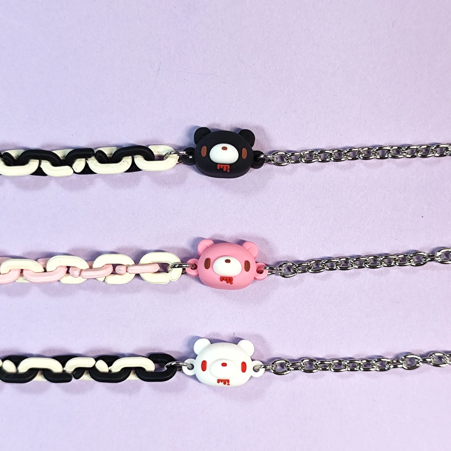 Set of three bracelets with cute bear charms in black, pink and white. Color - contrasting chains make them trendy and charming.