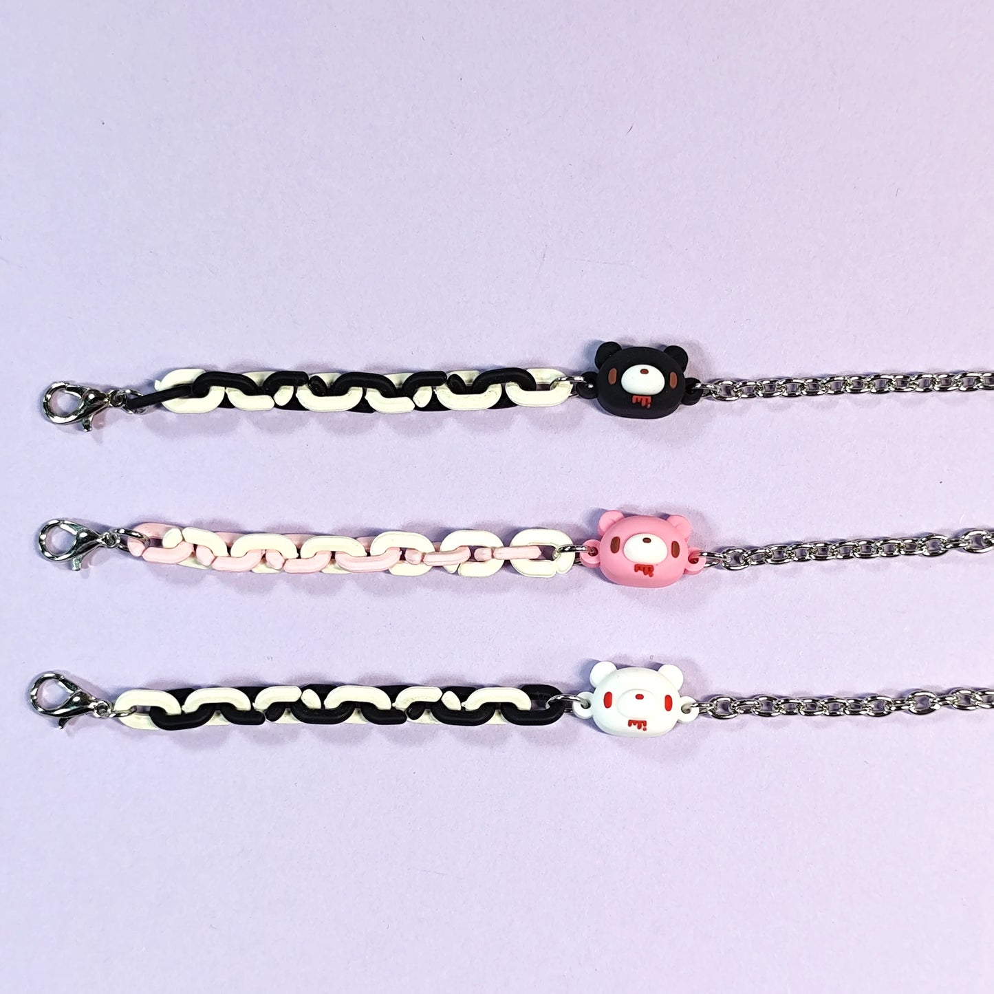 Set of three bracelets with cute bear charms in black, pink and white. Color - contrasting chains make them trendy and charming.